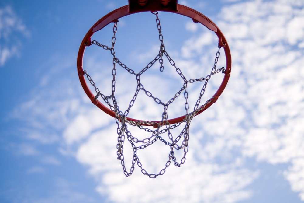 orange basketball hoop under blue sky during daytime