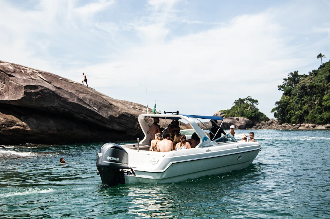 A white and blue motorboat underway on clear water