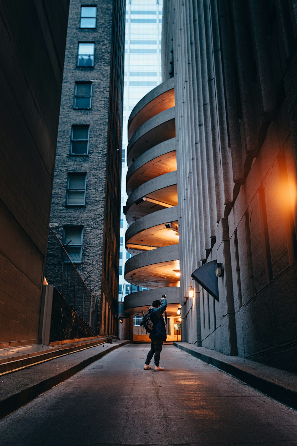 man in black jacket walking on sidewalk during daytime