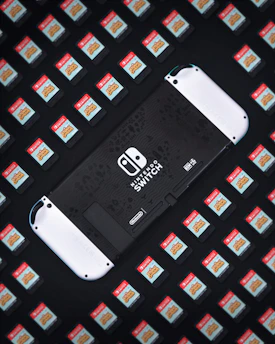 A vibrant collage of Nintendo Switch game covers and consoles arranged dynamically