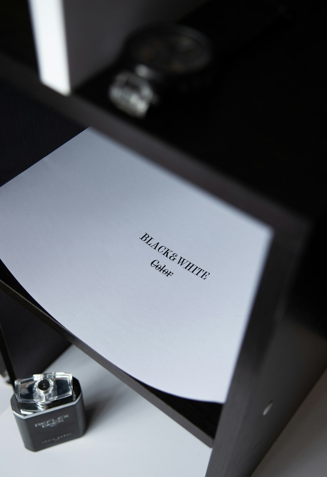 silver macbook on black table