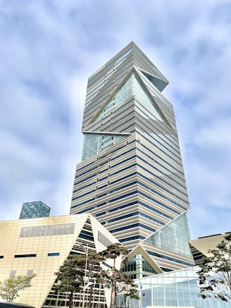 gray concrete building under cloudy sky during daytime