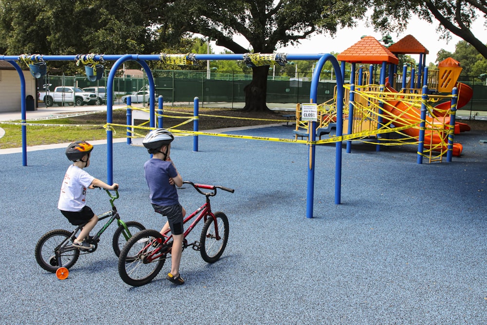 girl in blue and pink bicycle helmet riding bicycle during daytime