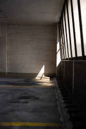 A neatly cleared garage with sunlight streaming in, showing a freshly cleaned space ready for use.