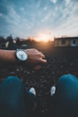 A sunset view with a watch in the foreground, symbolizing time.