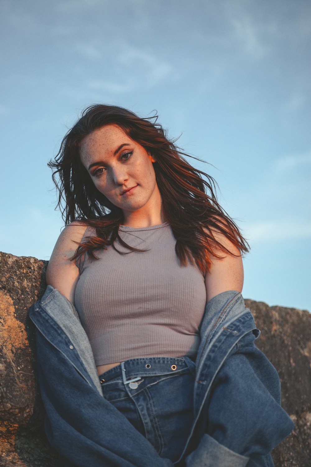 woman in white tank top and blue denim jacket