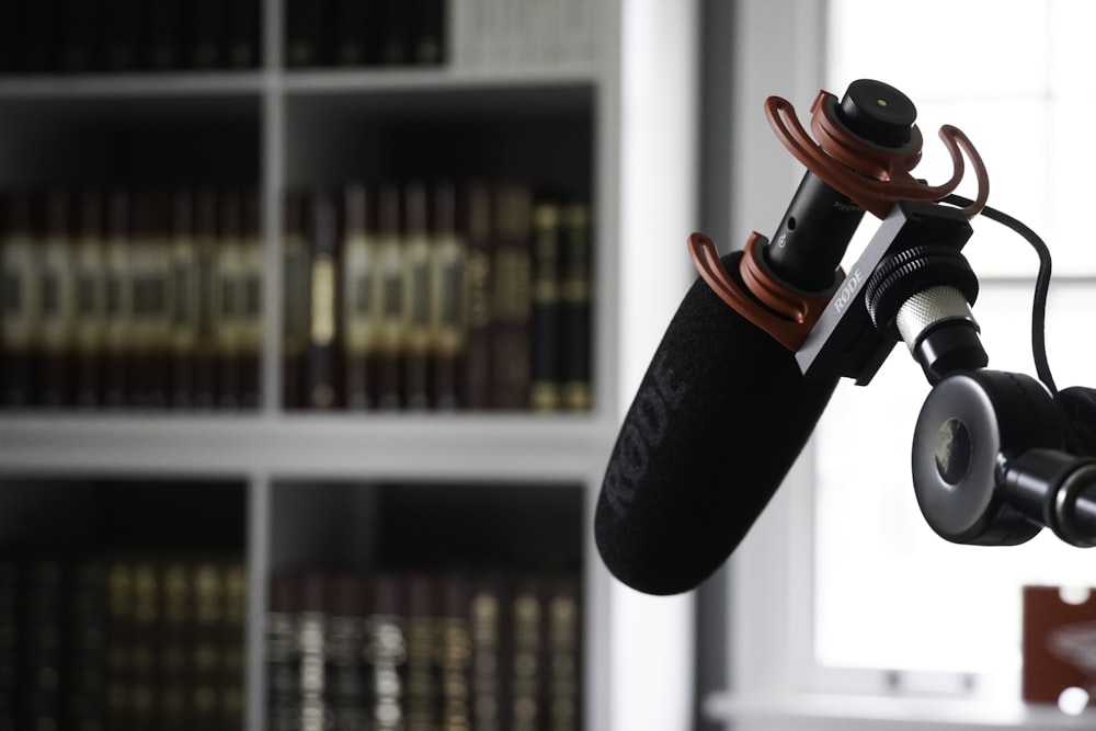 black and red bottle on white wooden shelf