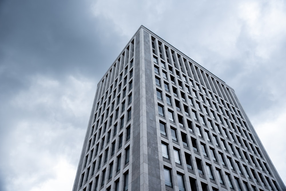 gray concrete building under white clouds during daytime