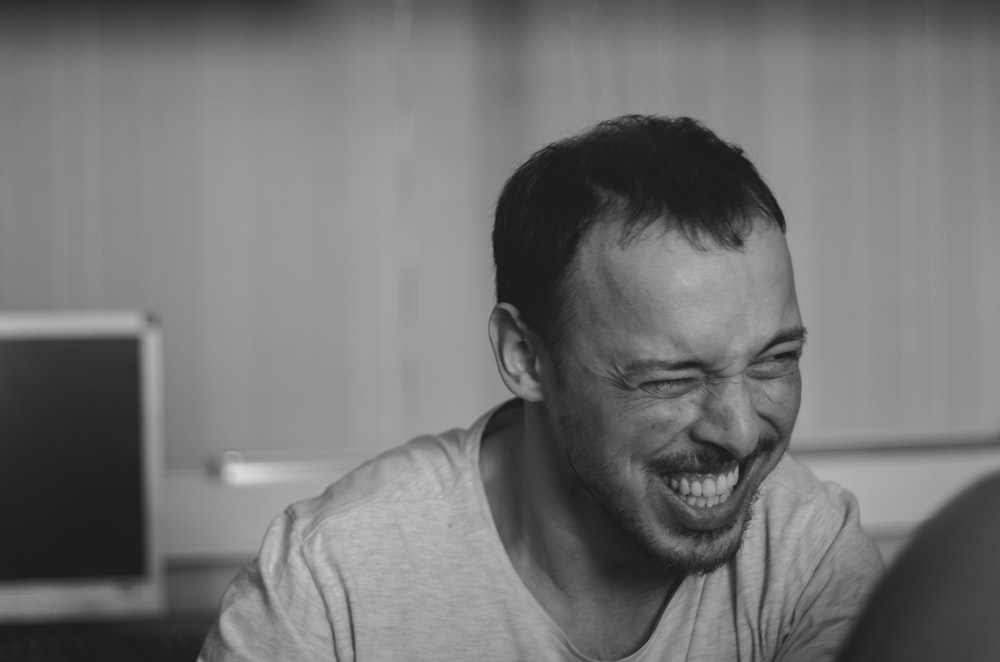 man in crew neck shirt smiling