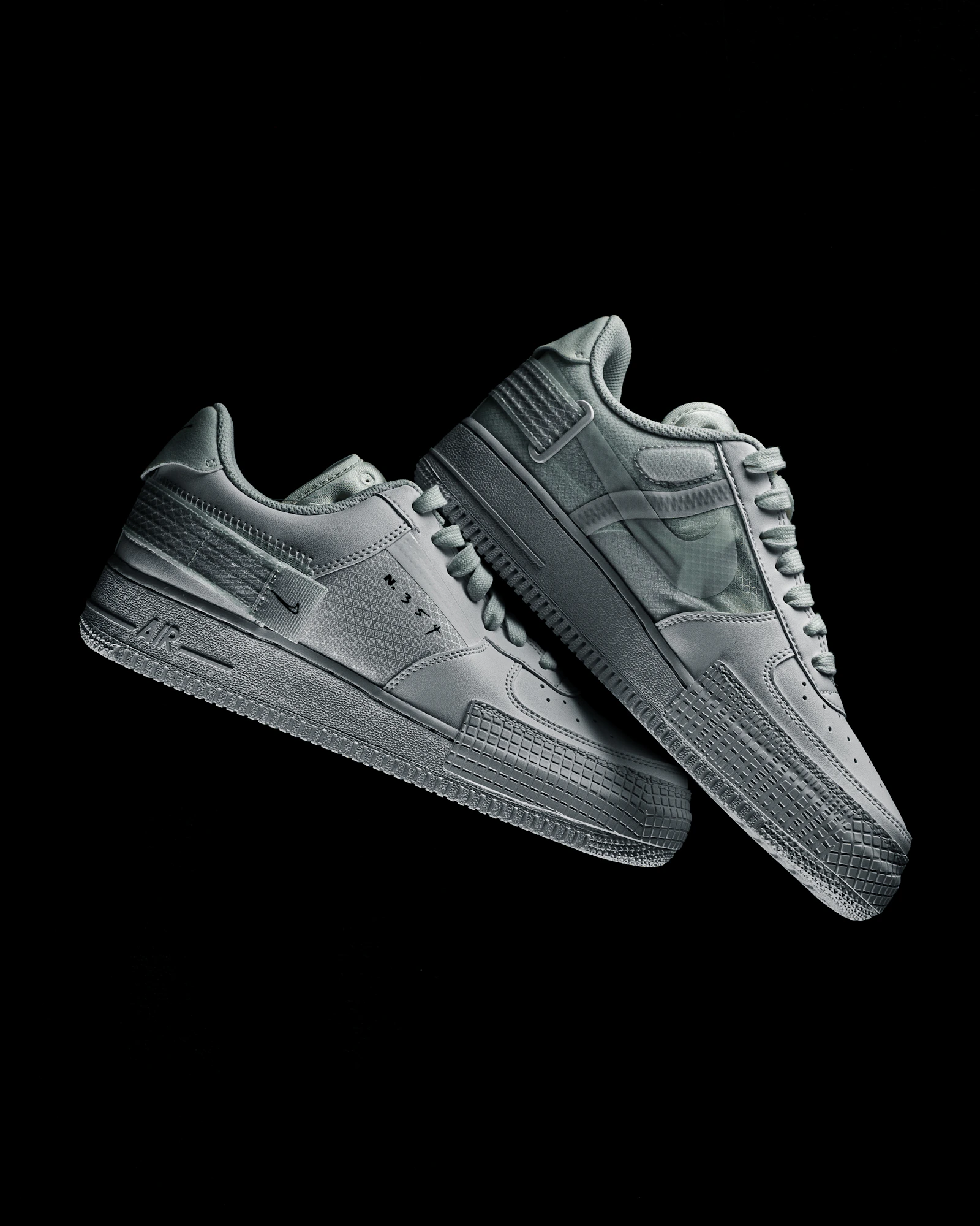 Pair of white Air Force 1 on black