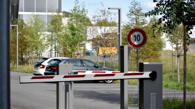 white and red sedan on road during daytime