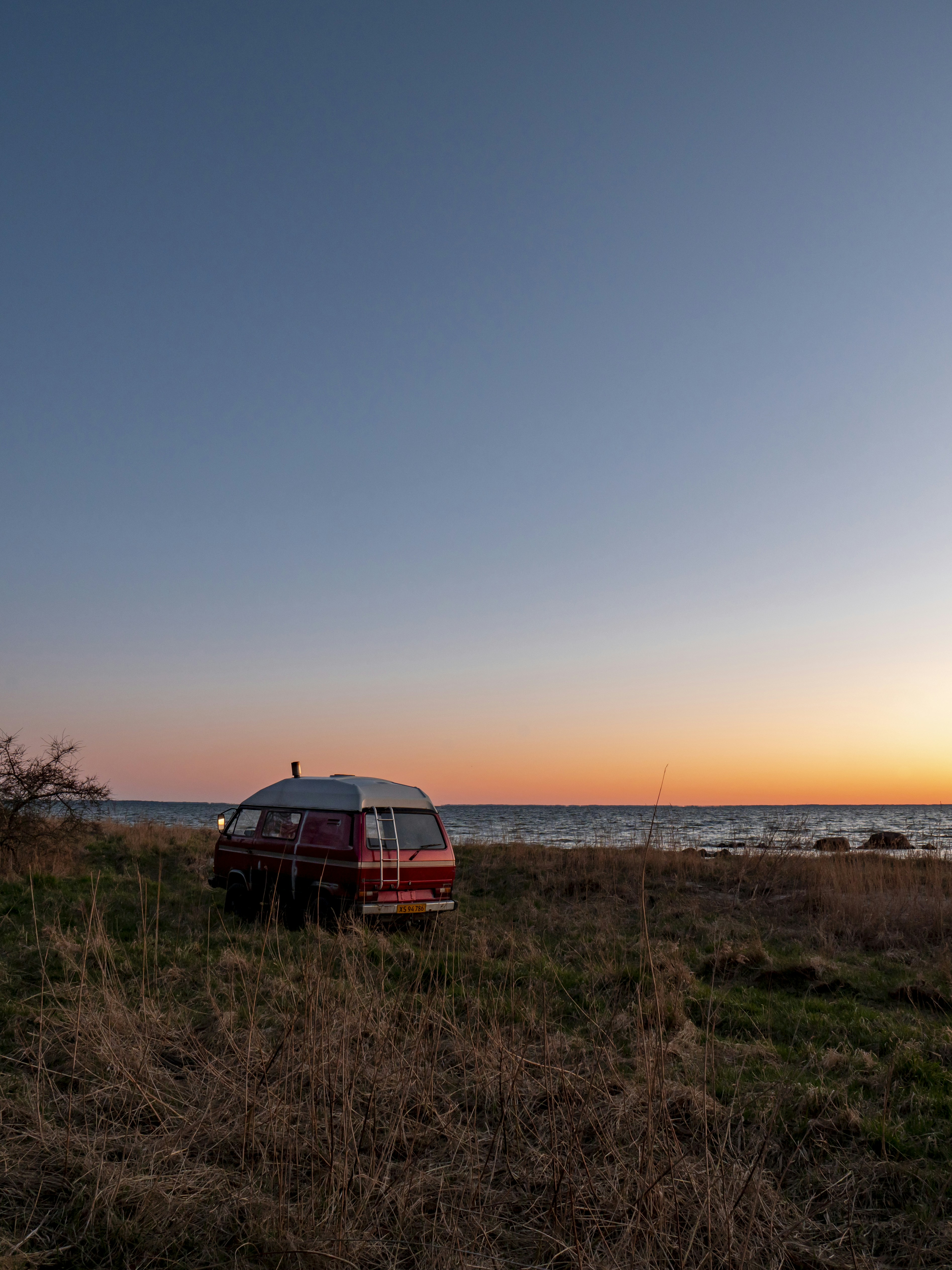 red car on brown field during daytime