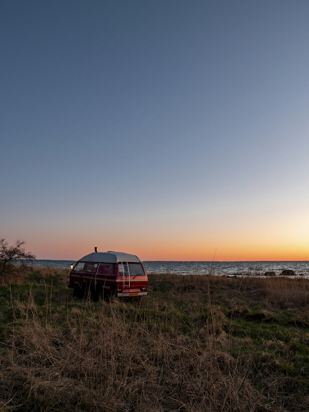 red car on brown field during daytime