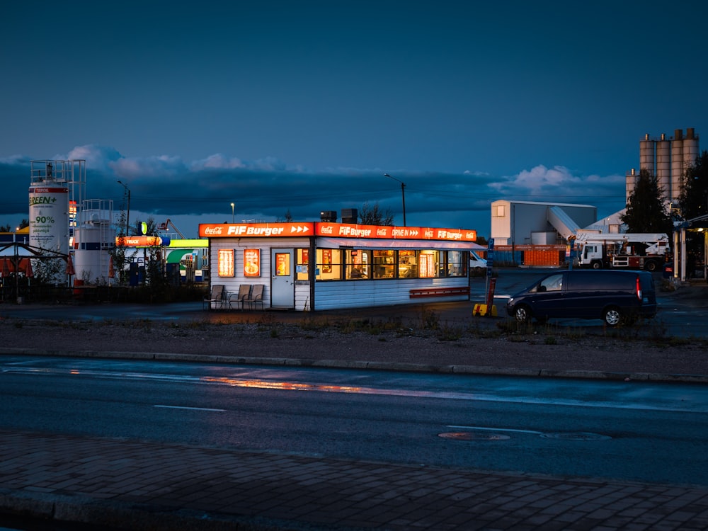 white and red food truck on road during night time