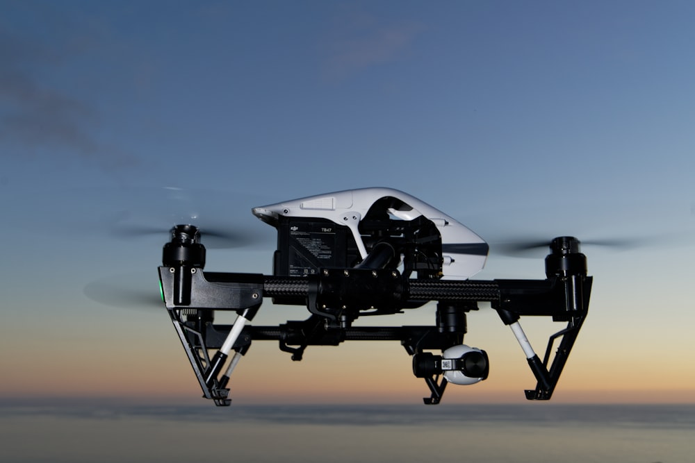 black and white drone on brown sand during daytime