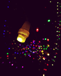 Close-up of a glowing LED bulb with a sleek black and blue background.