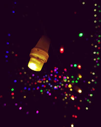 A close-up of a glowing yellow star-shaped light against a dark blue background.