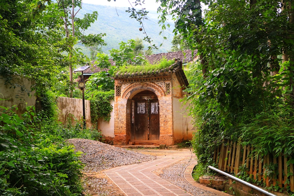 brown brick arch near green trees during daytime