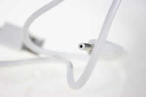 A close-up of a high-quality HDMI cable plugged into a sleek modern TV.