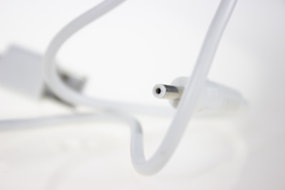 Close-up photo of a modern fiber optic cable connector in a clean environment.