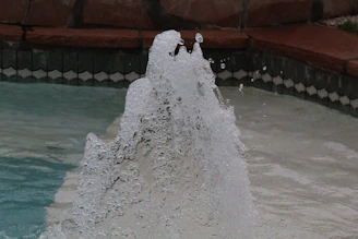 Close-up of a powerful Pentair motor pump in action with water splashing.