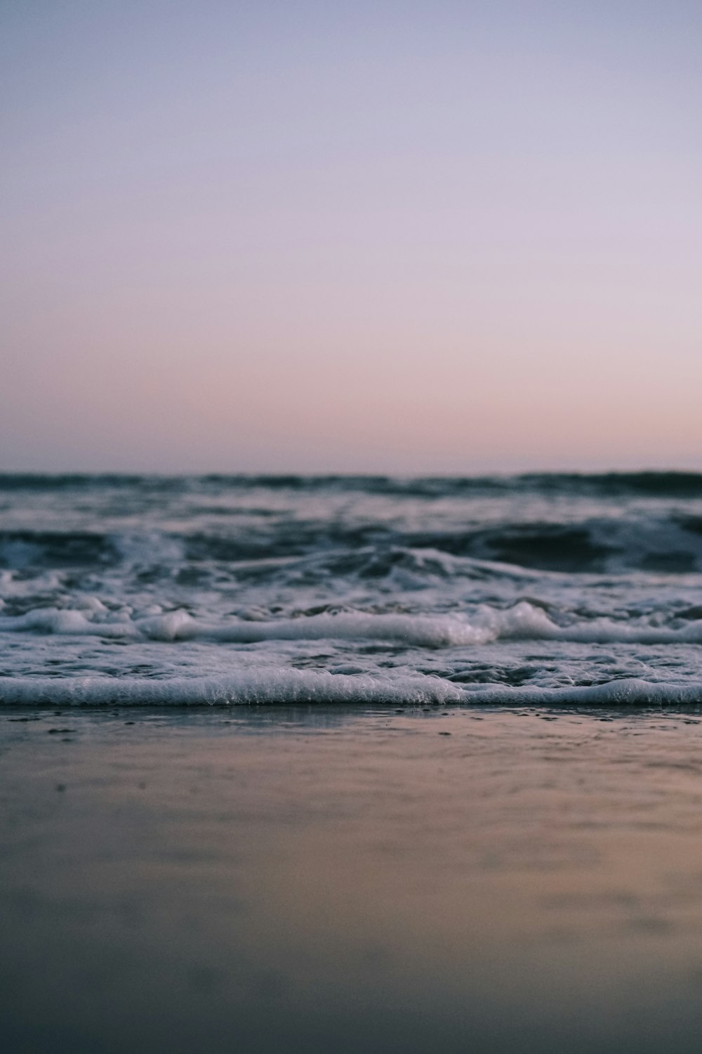 ocean waves crashing on shore during daytime