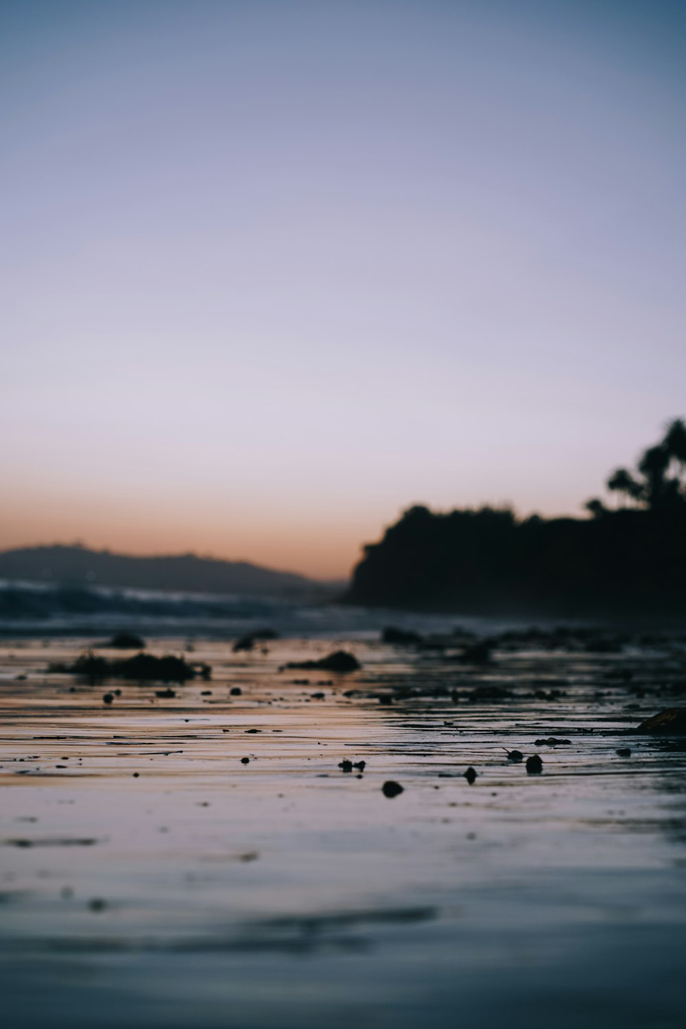 water droplets on the shore during sunset