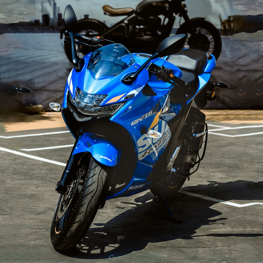 blue and black sports bike on gray concrete road