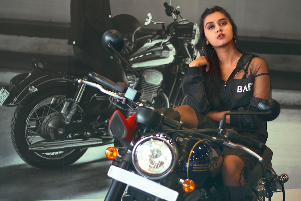 woman in black leather jacket sitting on black motorcycle