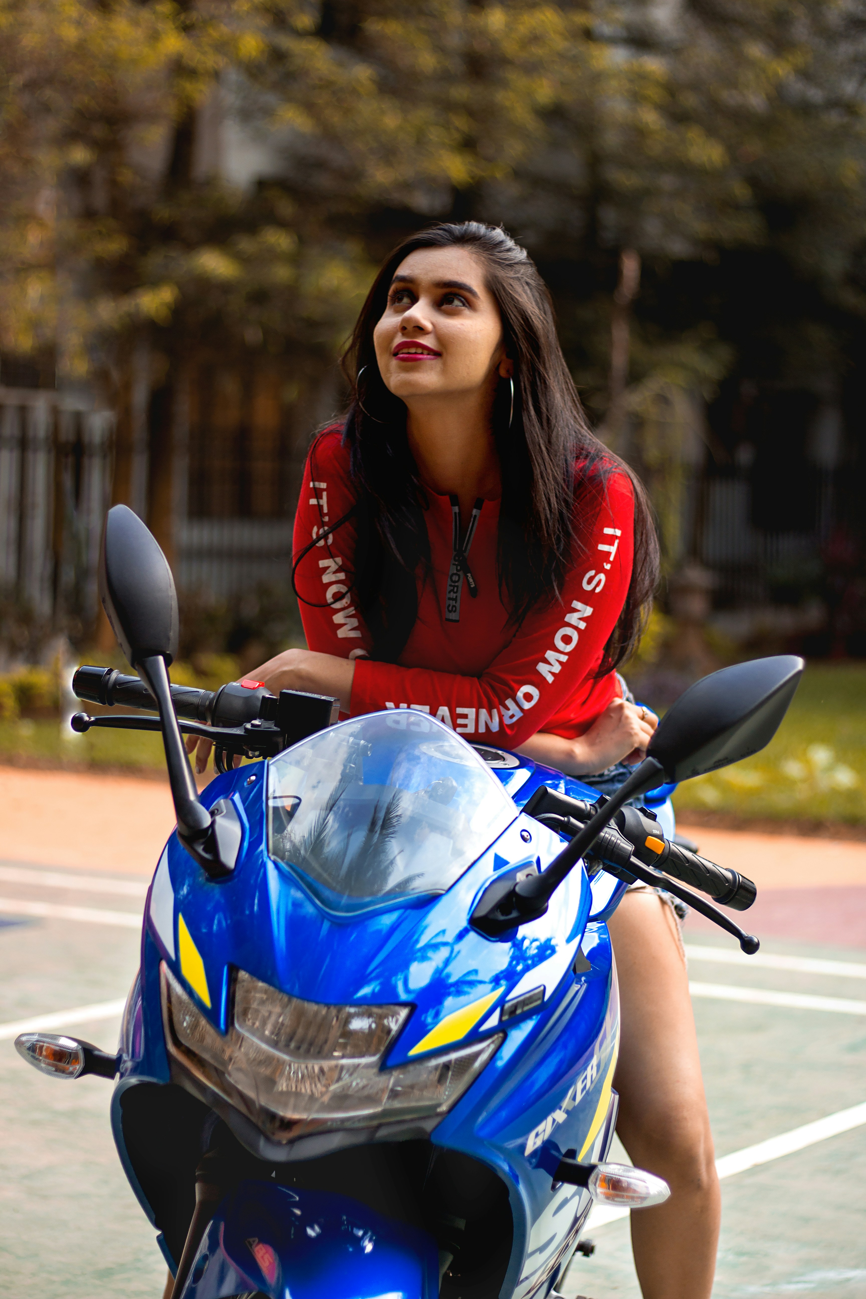 Woman in red jacket riding blue and black sports bike photo – Free ...