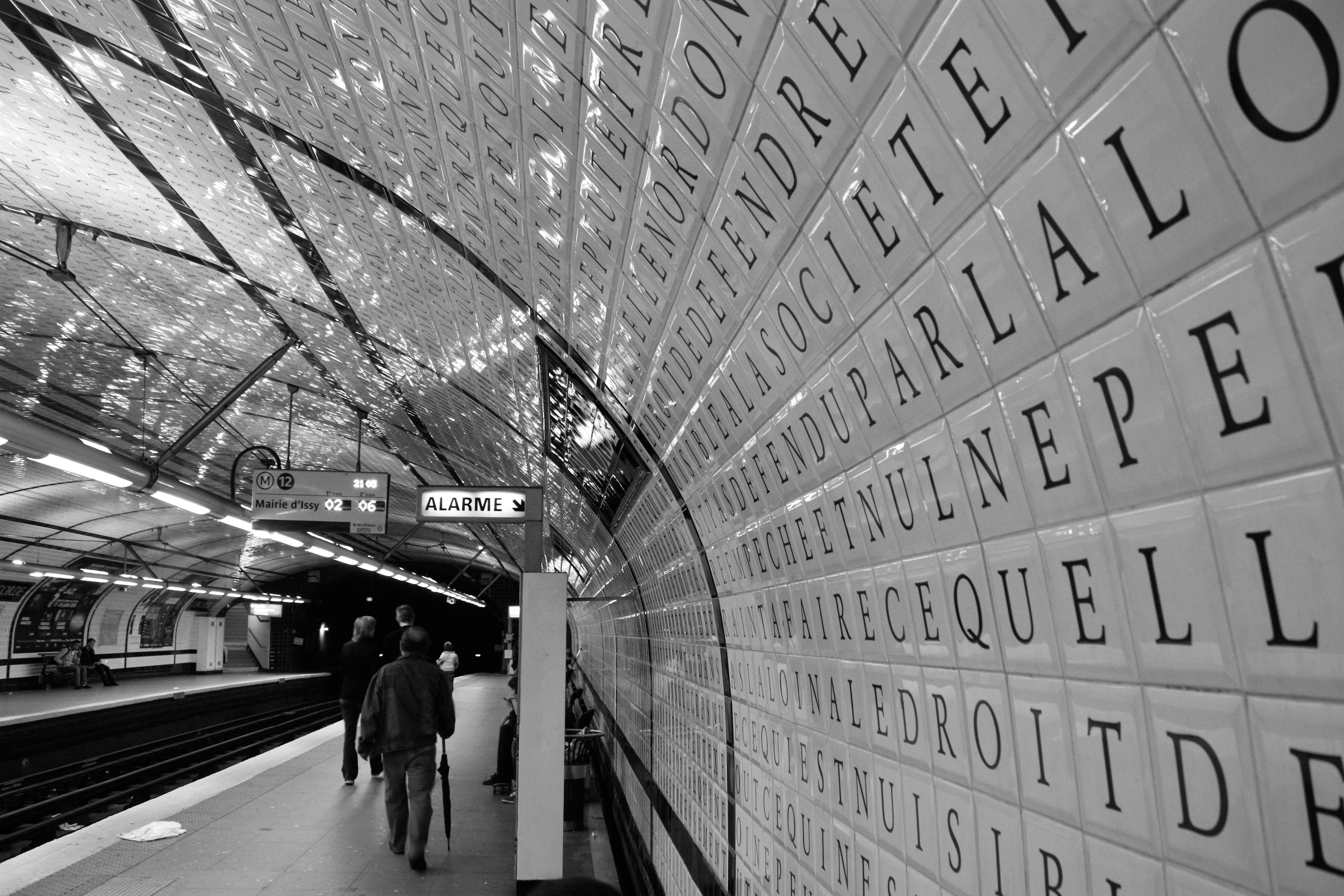 grayscale photo of people walking on sidewalk, 