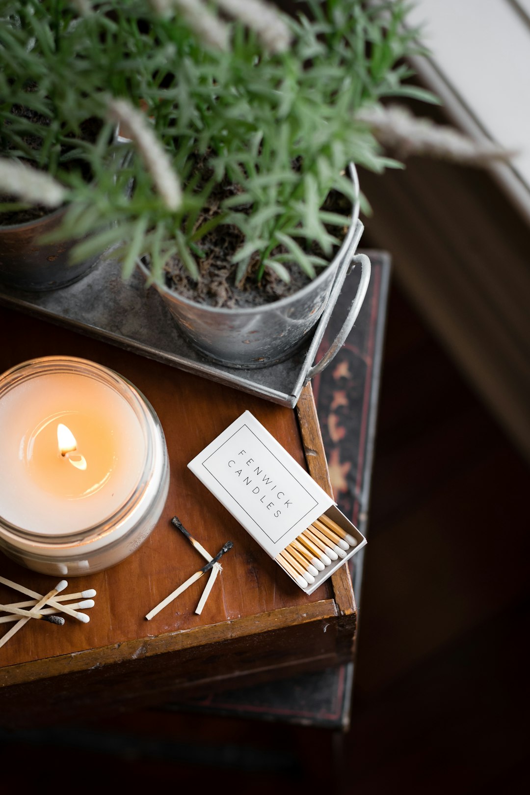 white candle on clear glass holder