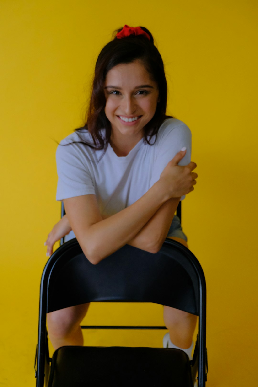 woman in white crew neck t-shirt sitting on black chair
