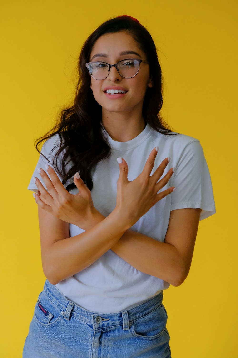 woman in white crew neck t-shirt wearing black framed eyeglasses