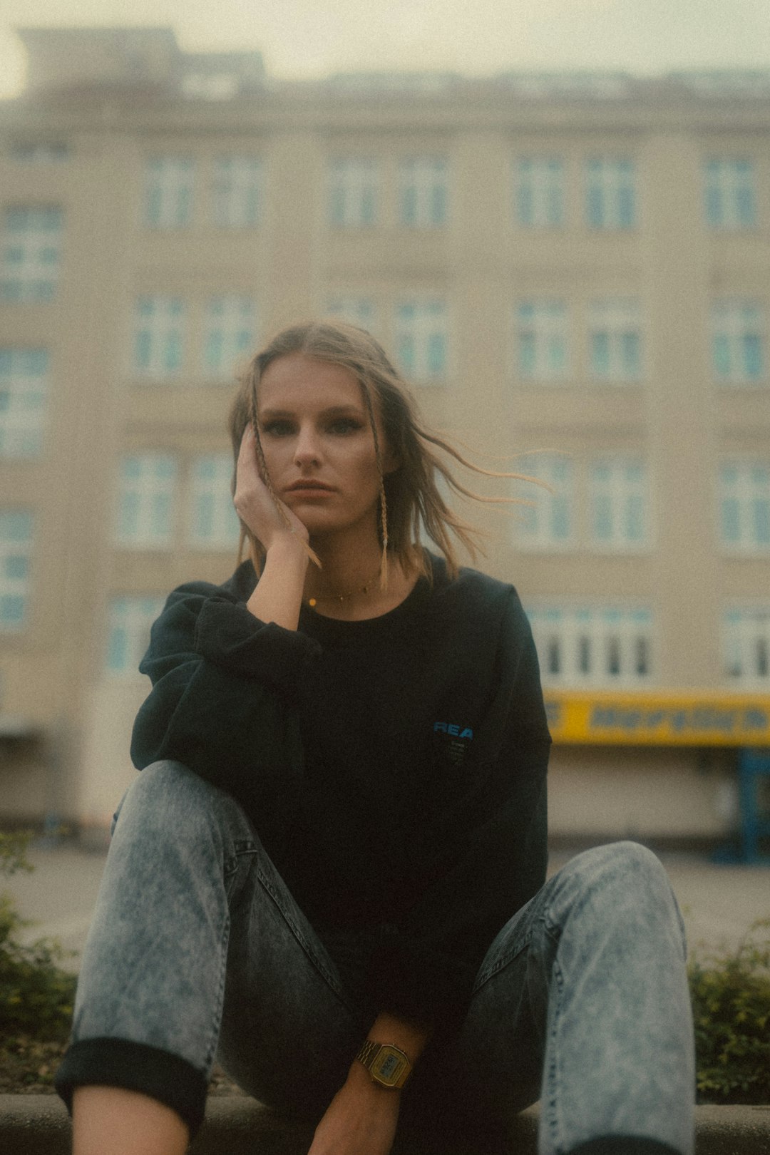 woman in black sweater sitting on white snow