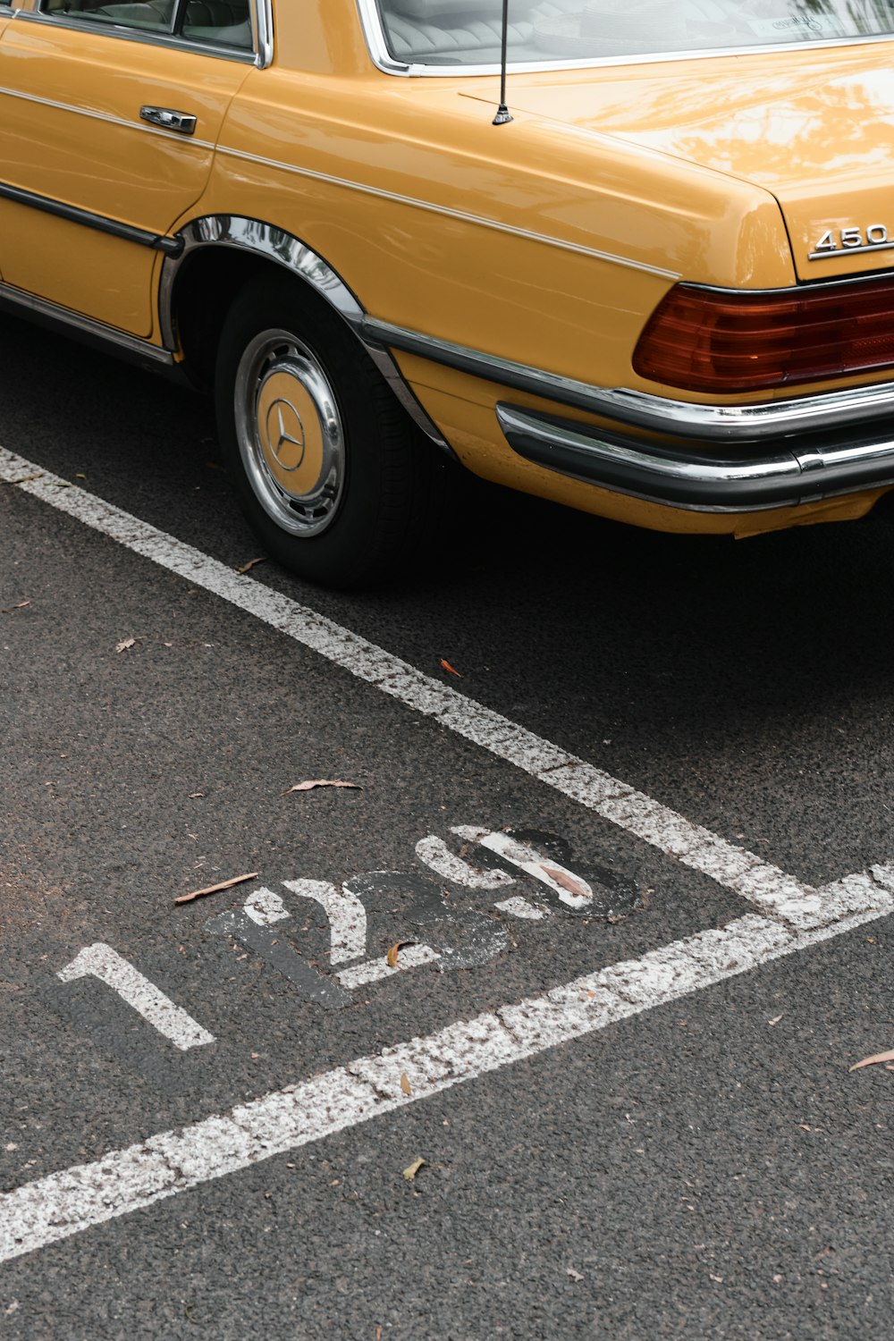 yellow car on black asphalt road