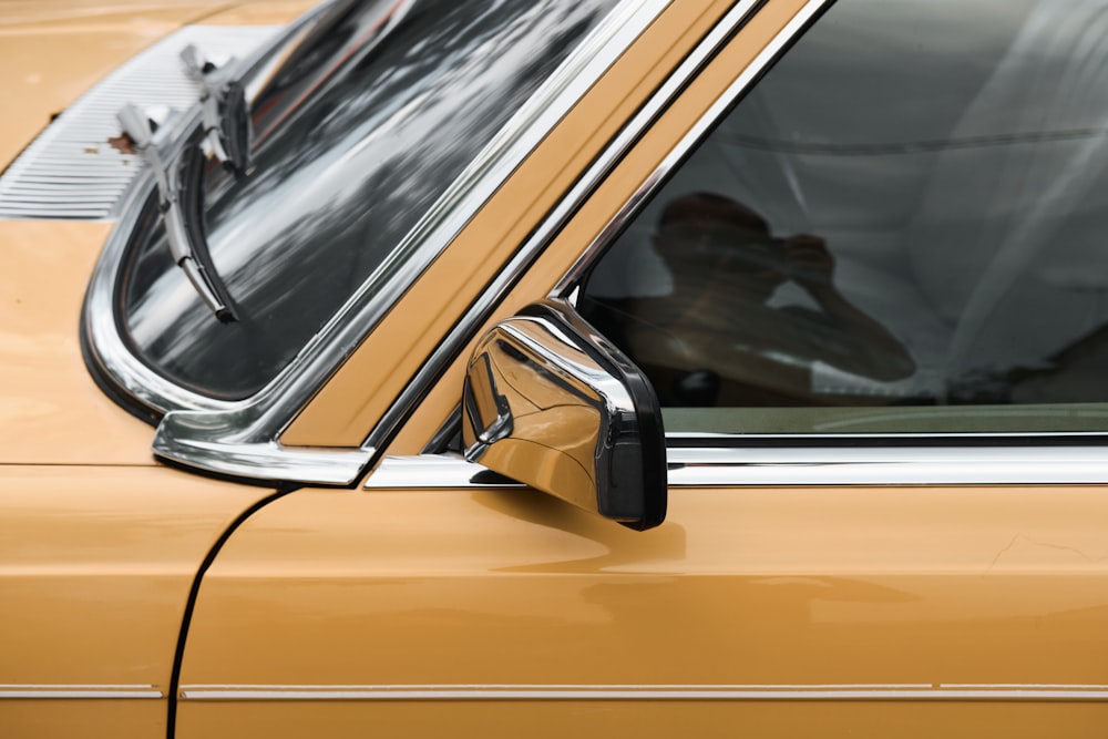 yellow car with black and silver door handle