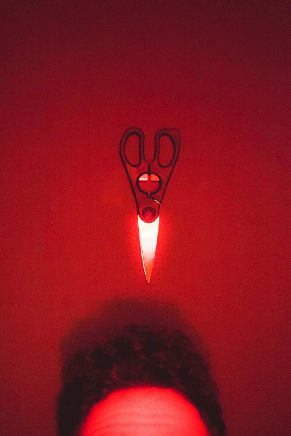 black handled scissors on red textile