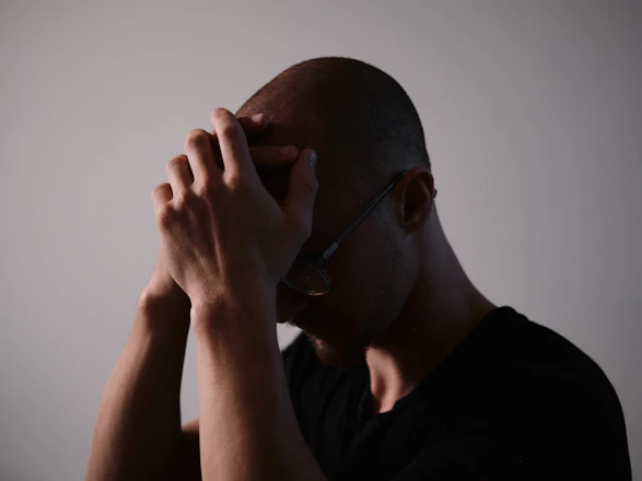 man in black crew neck shirt wearing black framed eyeglasses