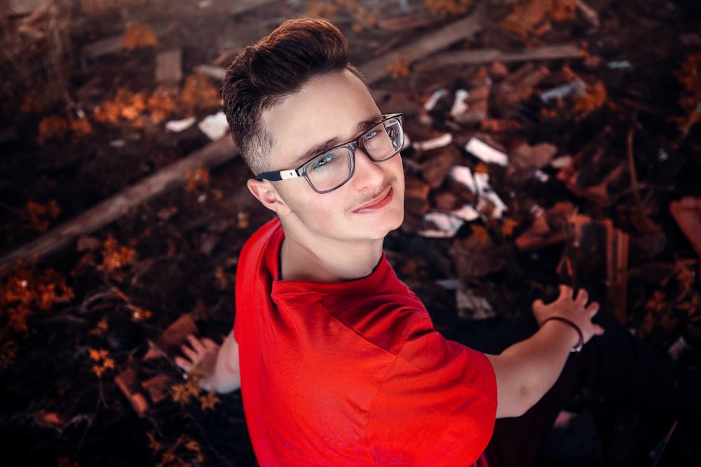 woman in red long sleeve shirt wearing black framed eyeglasses