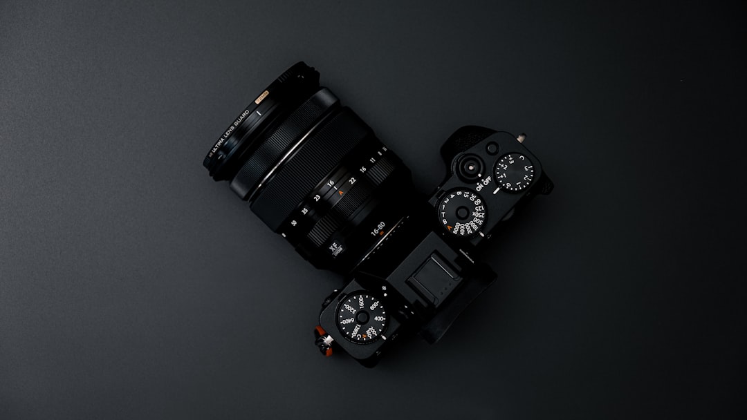 black dslr camera on gray surface
