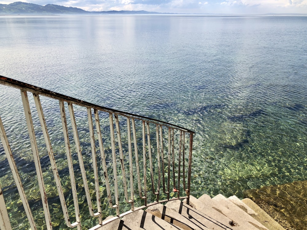 brown wooden staircase on body of water during daytime