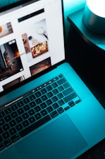 A glowing laptop screen displaying a futuristic website interface with smooth animations.