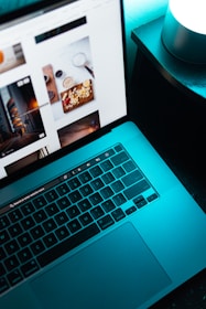 A glowing laptop screen displaying a futuristic website interface with smooth animations.