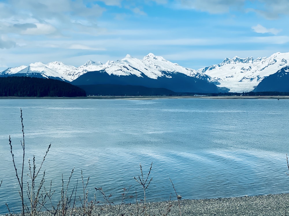 a large body of water with mountains in the background