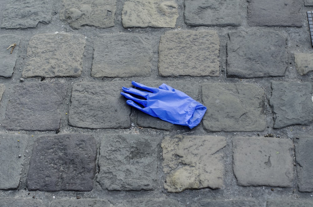blue umbrella on gray brick floor