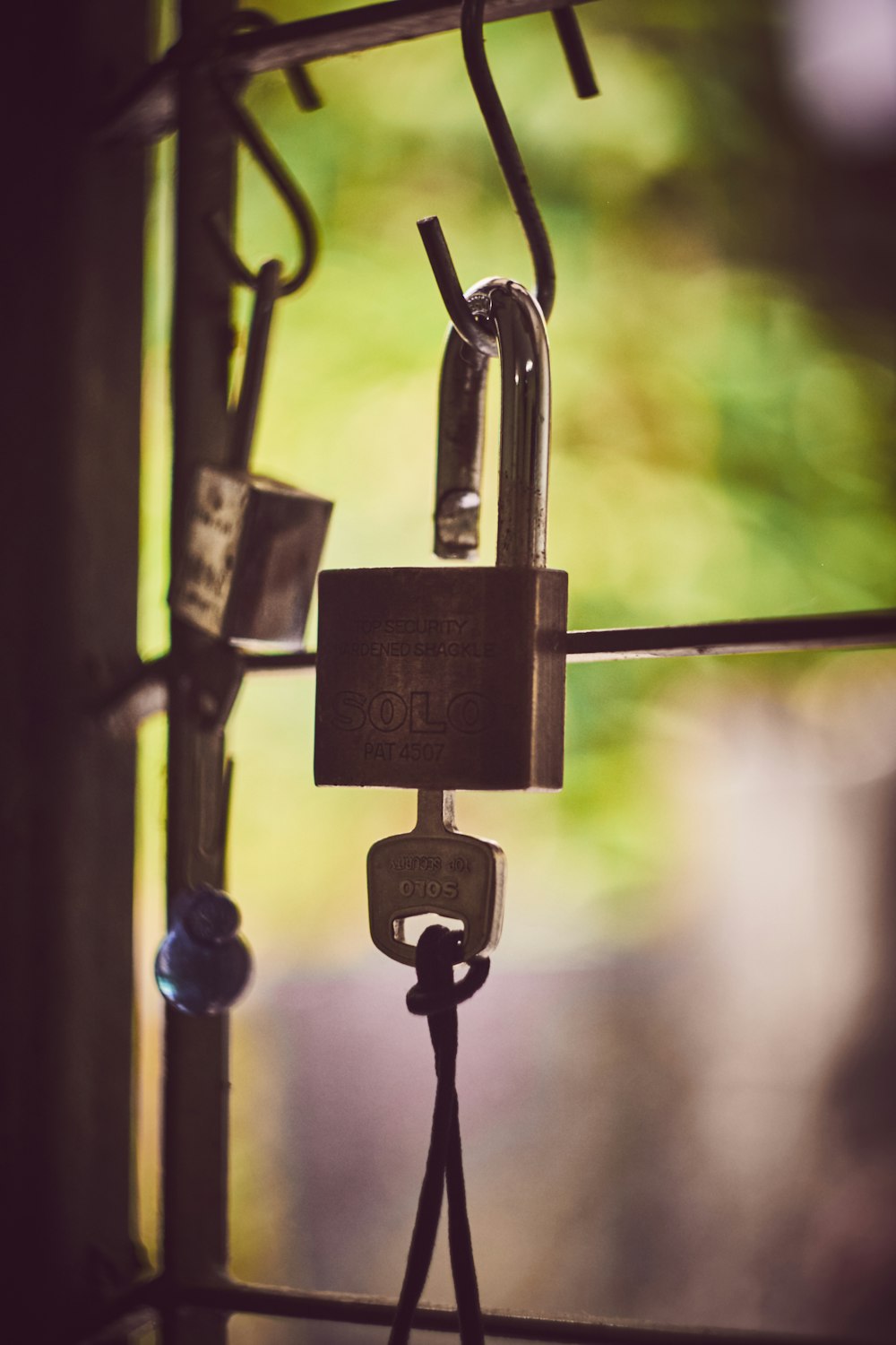 silver padlock on black steel fence