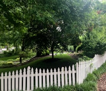 A sturdy, stylish fence enclosing a cozy garden space in a suburban neighborhood.