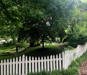 Cozy family home with a lush garden and a white picket fence.