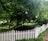 A well-maintained wooden fence surrounding a lush green garden.